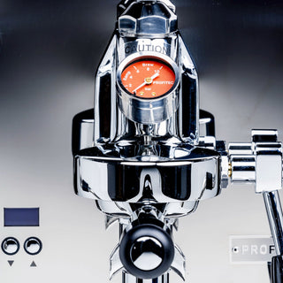 Front close up of Profitec DRIVE espresso machine with red pressure gauge and chrome finish.