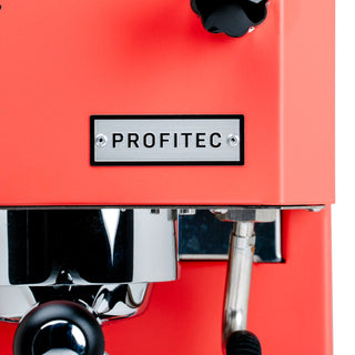 Close-up of the Profitec logo plaque on a red GO espresso machine