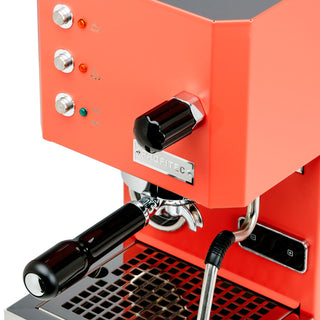 Red Profitec GO espresso machine with chrome knobs and a large black portafilter handle