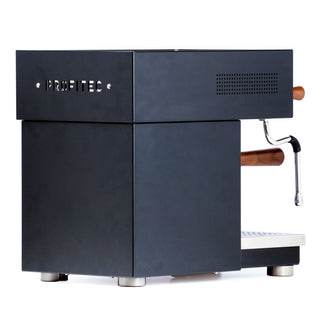 Side profile of Profitec MOVE showing logo on matte panel, vented area and a wooden portafilter handle