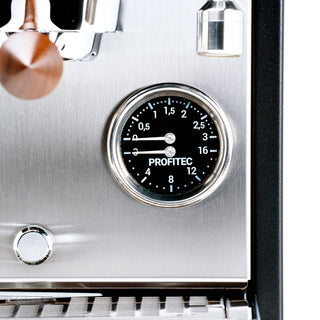Close-up of Profitec MOVE pressure gauge on brushed stainless panel with copper control knob.