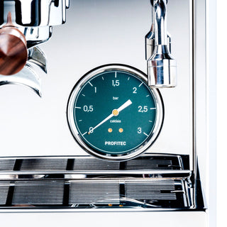 Close up of teal pressure gauge on Profitec Pro 800 showing bar scale and chrome fittings.