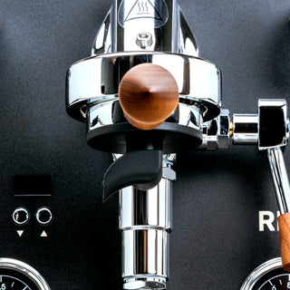 Close up of Profitec RIDE espresso machine chrome body with a wooden lever knob.