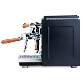 Side profile of Profitec RIDE espresso machine with chrome group head and wooden portafilter handles