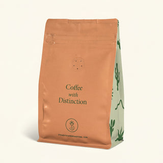 Peach colored Way Out Blend Organic coffee bag with a white label showing the product name
