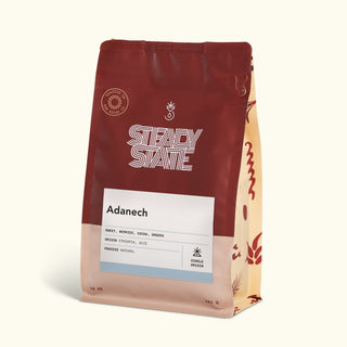 Adanech coffee bag in deep red packaging with a white label attached