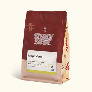 Magdalena coffee bag with white label reading Magdalena on a maroon packaging with bold typography.