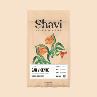 Colombia San Vicente coffee bag featuring peach packaging with bold typography and floral illustration