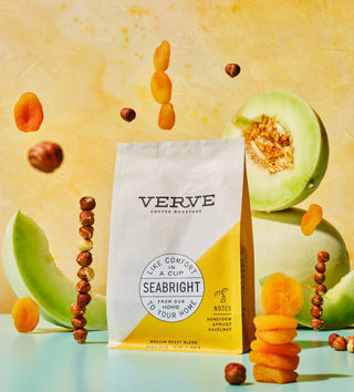 Seabright House Blend bag by Verve in a bright setup with melon slices and dried fruit around the yellow accent panel.