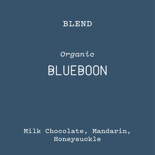 Blueboon organic blend label on a blue background with notes Milk Chocolate Mandarin Honeysuckle.