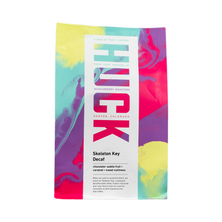 Skeleton Key Decaf coffee bag with colorful abstract artwork and a white label