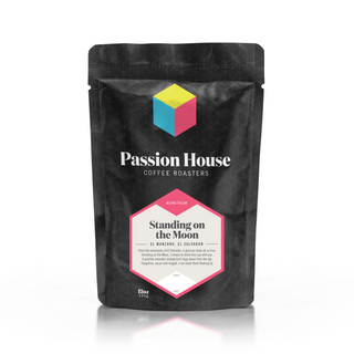 Front of Standing on the Moon Costa Rica coffee bag featuring bold label and colorful cube logo against a black geometric backdrop