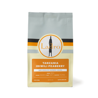 Front of a Tanzania Idiwili Peaberry coffee bag featuring the Ladro logo and orange label.
