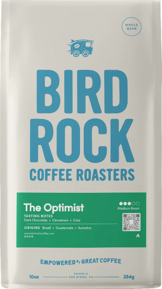 Bird Rock Coffee Roasters The Optimist whole bean bag front with bold blue lettering and green tasting notes panel.
