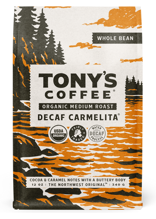 Decaf Carmelita whole bean coffee bag with bold forest and orange artwork and organic badges