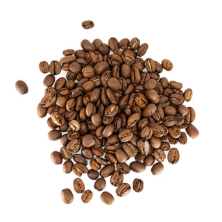 Roasted coffee beans spread on white background with a Topeca bag and pour-over setup