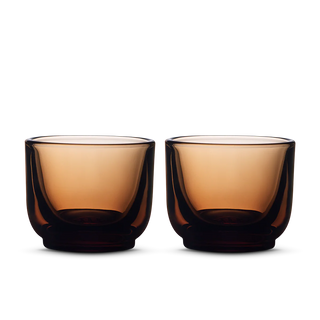 Pair of deep amber Fellow Pirch espresso shot glasses side by side