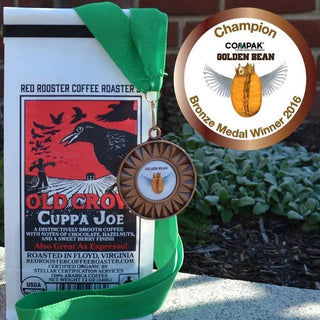 Organic Old Crow Cuppa Joe coffee package with bronze medal and green ribbon