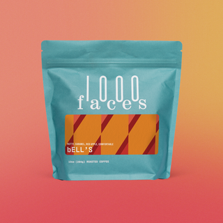 Turquoise bag of bell's coffee from 1000 Faces with an orange striped label and roasted coffee note