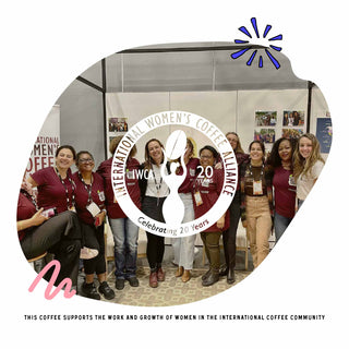 Group of smiling attendees at a coffee community event with a circular emblem overlay