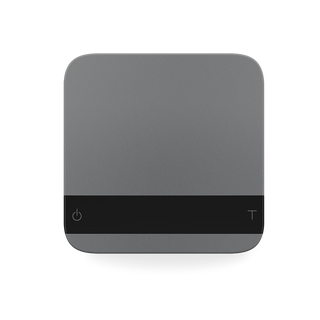 Gray Acaia Lunar espresso scale on a white surface showing a dark horizontal band