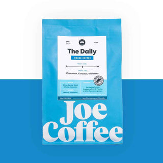 Bright blue The Daily coffee bag with white label and Joe Coffee branding