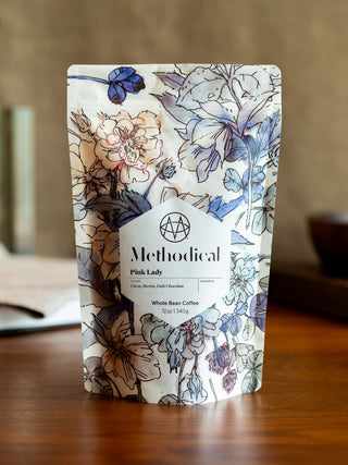 Pink Lady whole bean coffee bag by Methodical Coffee with a blue floral pattern.