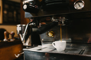 Espresso machine pours a shot into a white cup, illustrating Blacksmith Espresso Blend.