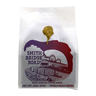 Smith Bridge Road Blend coffee bag with a purple bridge graphic and dark roast branding.
