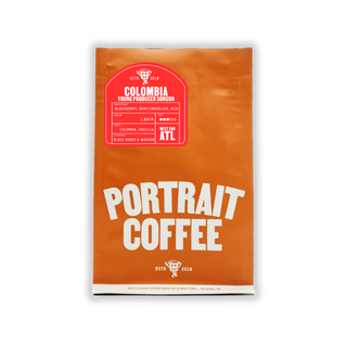 Portrait Coffee Colombia Sonson Black Honey bag with bold white PORTRAIT COFFEE on bright orange packaging