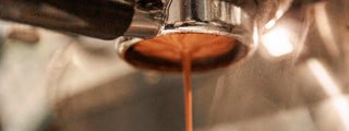 Espresso dripping from a portafilter during extraction